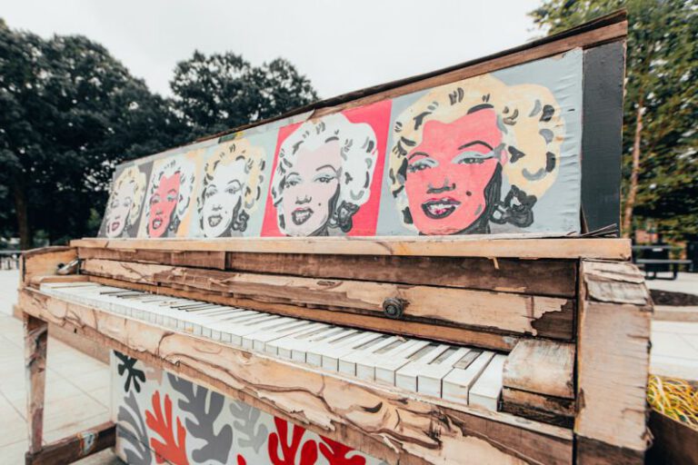 Celebrity Retreat - white and red graffiti on brown wooden fence