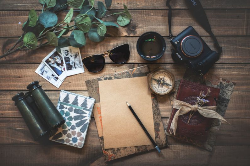 Travel Gadgets - photo of assorted items on wooden table