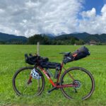 Packing Cubes - red and black mountain bike on green grass field during daytime