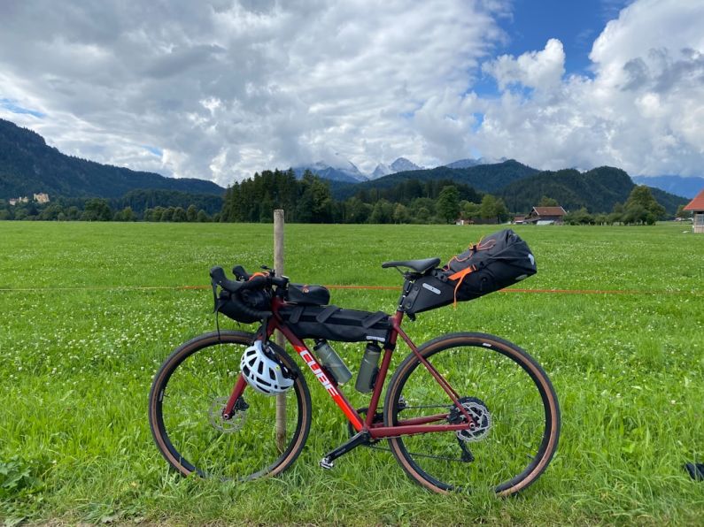 Packing Cubes - red and black mountain bike on green grass field during daytime