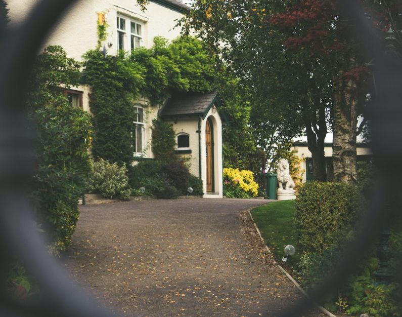 Luxury Packing - minimalist photography of house shot in front of chain fence