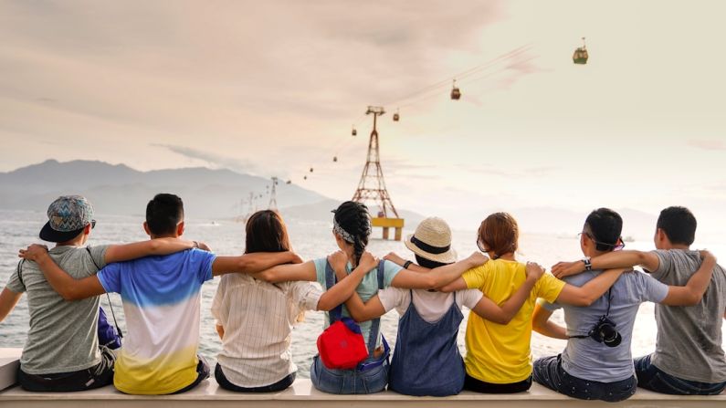 Making Friends - people holding shoulders sitting on wall