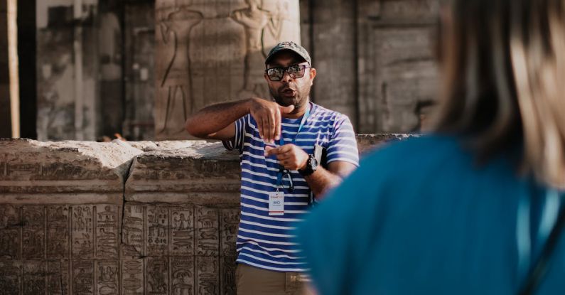 Educational Travel - A Man in Striped Shirt Serving as Tour Guide