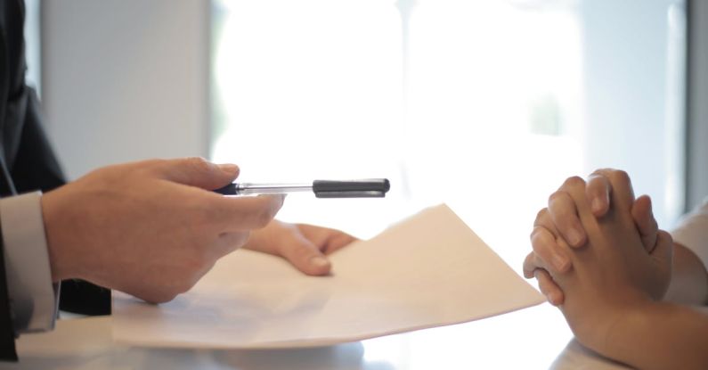 Family Deals - Crop businessman giving contract to woman to sign