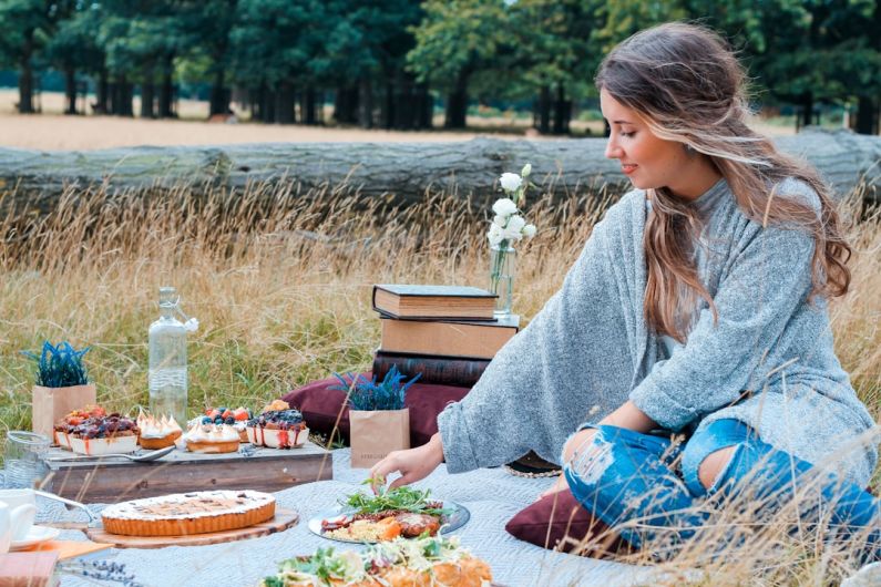 Nomad Family - woman sitting on picnic mat