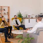 Co-living - people seated in living room