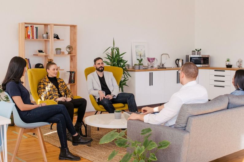 Co-living - people seated in living room