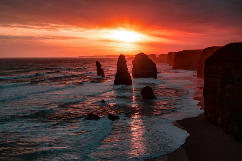 Outback Sunset - silhouette of stone on seashore during golden hour