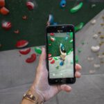 Smartphone Apps - a person taking a picture of a climbing wall