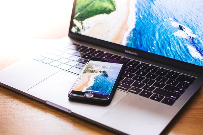 Laptop Beach - closeup photo of iPhone on MacBook Pro