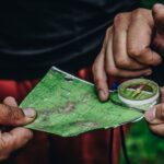 Map Compass - two person holding map and clear compass