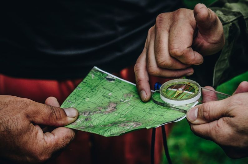 Map Compass - two person holding map and clear compass