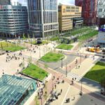 Bike Path - aerial photography of people walking on park near city buildings