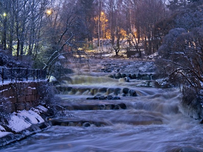 Rapid River - a river running through a forest covered in snow