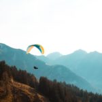 Paraglider - person paragliding near mountain at daytime