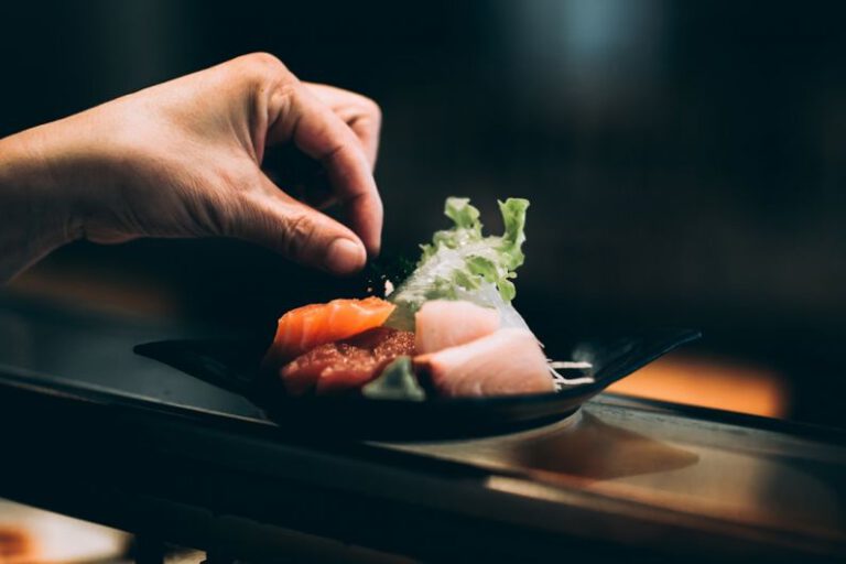 Sushi Plate - left hand picking vegetable on plate