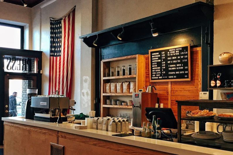 French Bistro - flag of U.S. America hanging on white painted concrete wall