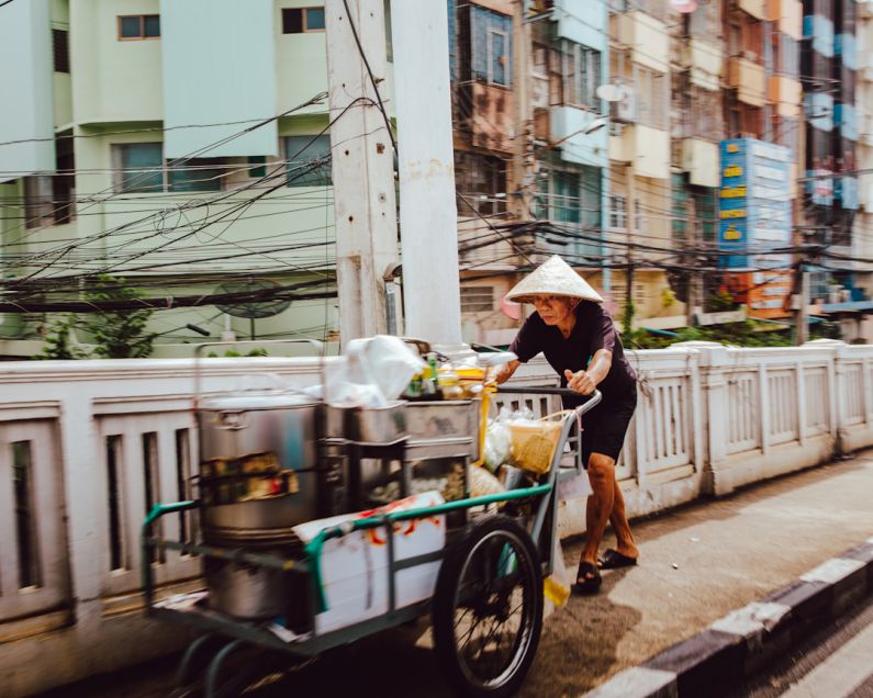 Thai Street Food - man pushing the cart on street