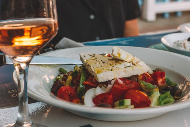 Greek Salad - sliced tomato and cucumber on white ceramic plate