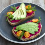 Hummus Plate - two sliced breads with avocado on top