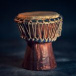 African Drum - selective focus photography of brown djembe instrument