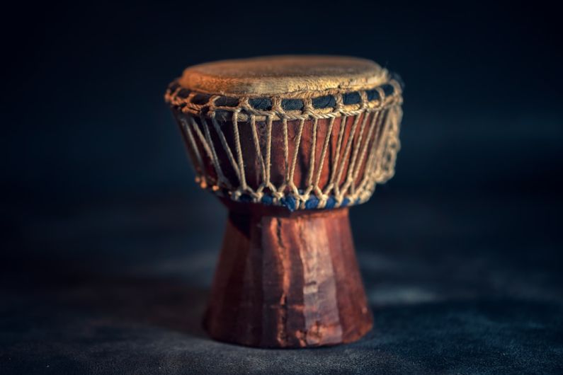 African Drum - selective focus photography of brown djembe instrument