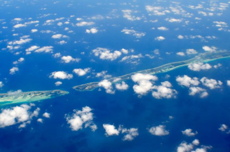 Maldives Exclusive - aerial photography of green island and clouds