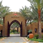 Dubai Luxury - the entrance to a resort surrounded by palm trees