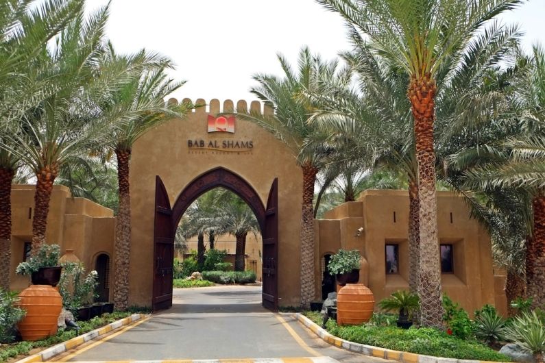 Dubai Luxury - the entrance to a resort surrounded by palm trees